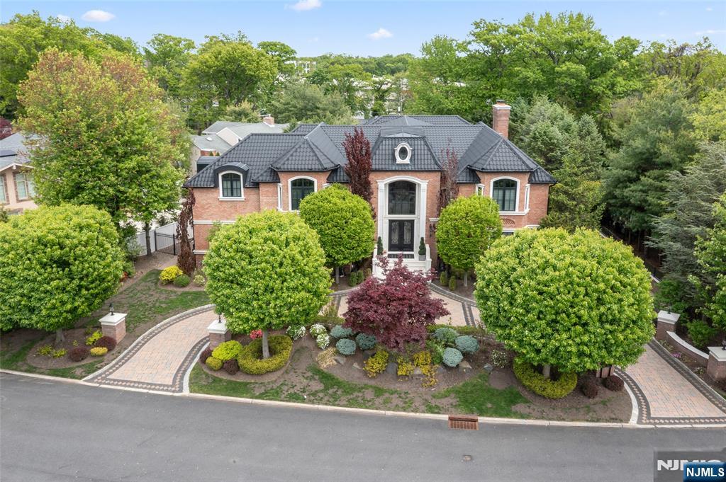 www.675summit.com 12,300 sq ft of CUSTOM LUXURY LIVING in the prestigious North Englewood Cliffs! This magnificent brick estate with Caribbean-style roof features a Grand Marble Foyer, formal Living & Dining Rooms, Home Theater, Office & Sauna. Two Gourmet Kitchens perfect for a Professional Chef equipped with 2 Wolf Stoves (10 burners, 4 ovens & 1 Warmer), 2 dishwashers, 2 islands, SubZero Pro Series Refrigerator, Miele Espresso station, custom cabinetry, breakfast area & Family Room with precast wood-burning fireplace with auto gas starter and a wall of custom French doors opening to the back patio. The 2nd floor Master Suite is an understatement: precast fireplace, Juliet balconies, 2 large walk-in closets, his & her baths with steam shower & sitting room. Four Bedroom Suites with marble baths, Jacuzzis & walk-in closets. Lower Level: Family Room, Bedroom, 2 Baths & gym area. 5-Car heated/AC Garage with Ceramic Tile. Hardwood & Radiant floors throughout. Saltwater Pool lined with Italian granite specs & Jacuzzi. Stunning grounds, whole-house Generator, Security camera system, Dual Laundry Room, Gated Circular Driveway. Low taxes & minutes to the GW Bridge to Manhattan!