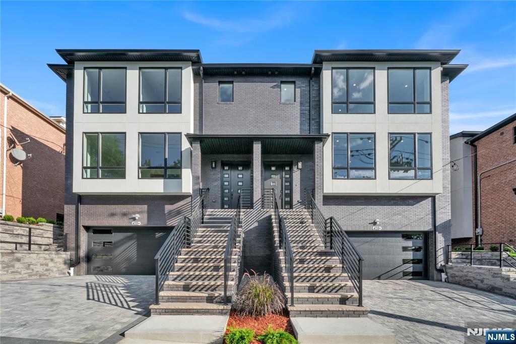 Welcome to 428 6th Street, an impressive oversized luxury townhouse perfectly positioned on a 75x100 lot in the heart of Palisades Park. Spanning over 4,600 sq. ft., this home offers soaring 9-foot ceilings on the main level and a thoughtfully designed open layout. The expansive living room transitions seamlessly into a formal dining room with built-in wet bar, ideal for entertaining. A cozy family room with fireplace adds warmth, while the chefâ€™s kitchen is the true centerpiece, featuring a massive center island, custom cabinetry, and premium finishes. Sliding glass doors open to a private, enclosed backyard, perfect for outdoor enjoyment. Upstairs, the primary suite boasts two generous closets and a spa-inspired bathroom with double vanity, soaking tub, and glass-enclosed shower. Three additional bedrooms provide comfort and flexibility for family or guests. All bathrooms upstairs feature radiant heat. The lower level is designed for versatility, complete with a true two-car garage, spacious recreation room, an additional bedroom or home office, and a convenient half bath. Blending scale, luxury, and functionality, this exceptional residence presents a rare opportunity to enjoy oversized living in one of Palisades Parkâ€™s most sought-after neighborhoods.