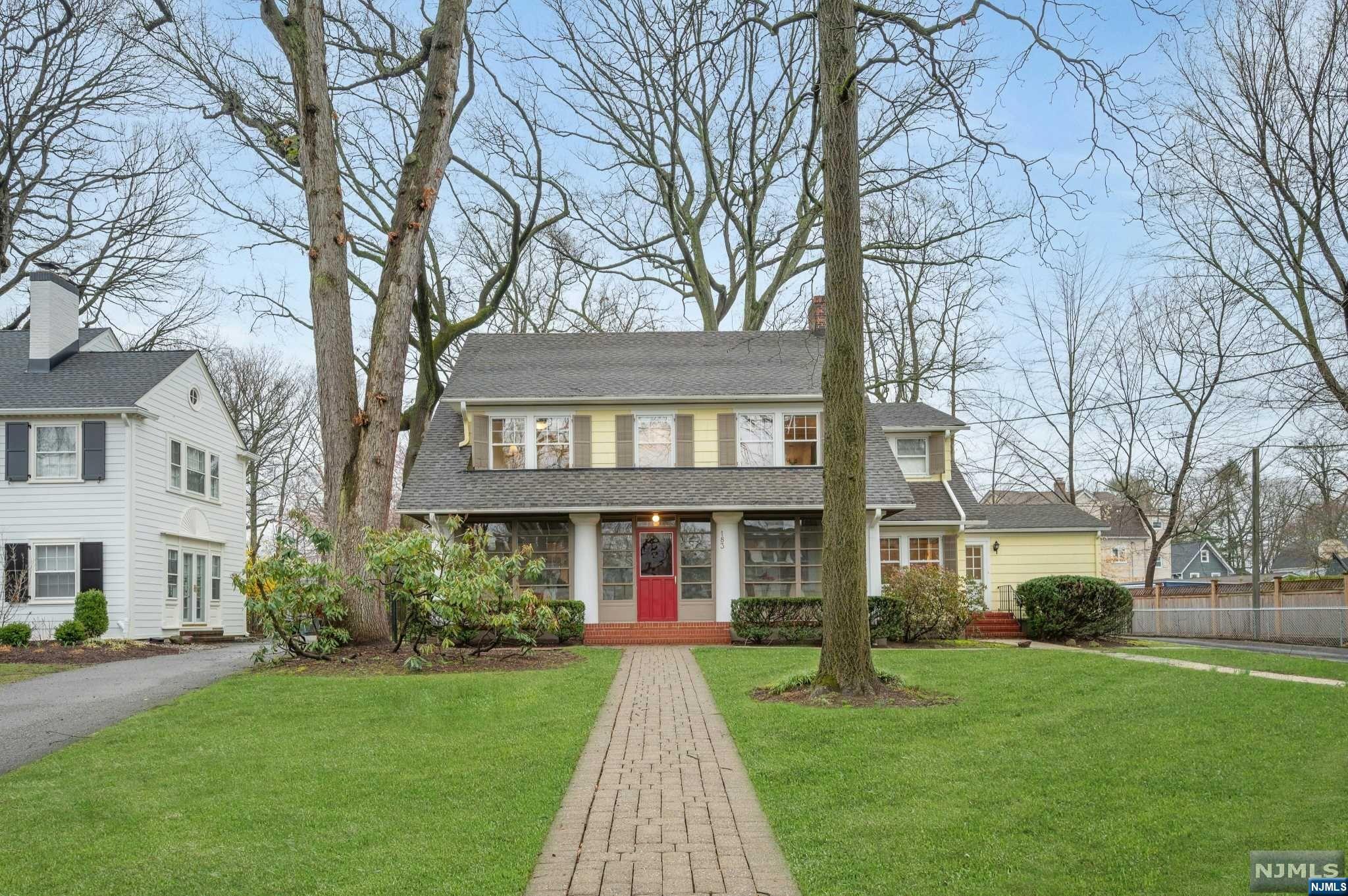 This warm and welcoming classic center hall colonial is located in the heart of Montclair, near the trains and amenities of Watchung Plaza, yet set back from the street in a quiet, park-like setting on a large lot with an abundance of mature oak, walnut, tulip trees and more. Enter through the spacious enclosed porch, and you'll find a large formal living room and dining room, complemented by a bright and cheerful modern kitchen that includes a 5-burner gas cooktop, an electric wall oven and a reverse osmosis water system. The first floor also boasts an unusual in-law suite, built with accessibility in mind, which includes a second living room and kitchen area, along with a good size bedroom, a full bath, an in-unit laundry and an office/sitting room. From the back of the main house you'll also find access to a hardwood deck leading to the deep back yard. On the second level, you'll enjoy the oversized primary bedroom with ensuite bath, and a private dressing/sitting room.