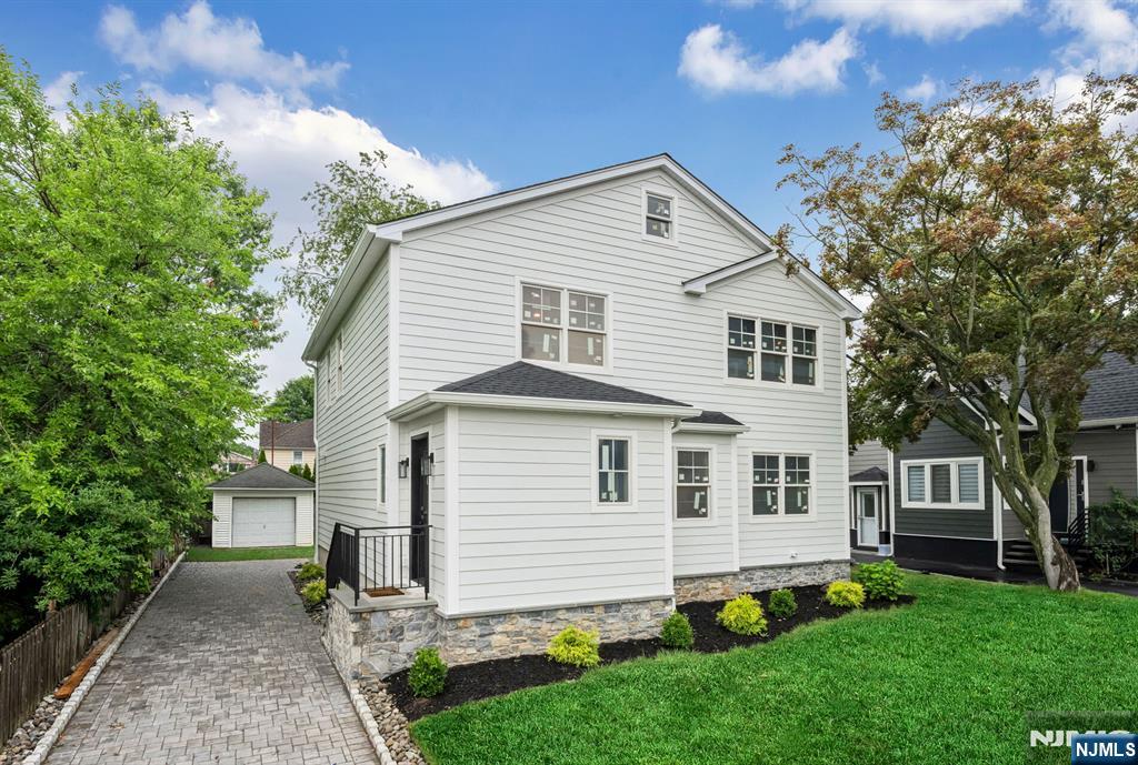 Welcome to this beautiful four BR, three-and-one-half bath side hall Col, ideally situated on a pretty street in Fair Lawn. The welcoming foyer flows into the DR and opens to a stunning, open-concept Kit featuring a large center isl w/quartz countertops, custom cabinetry, a subway tile backsplash, a SS sink, and appliances--perfect for both everyday living and entertaining! Open to the Kit is a spacious LR with a gas fpl w/custom mantel, elegant wainscoting, crown molding, and SGD leading to the bkyd. A private study, conveniently located off the LR, provides the perfect space for a home office! The second flr offers four generously sized BR's along with a LR and an additional storage closet. The luxurious primary suite features a WI closet and a beautifully appointed en-suite bath with a dbl vanity, oversized walk-in shower, and porcelain tile. The hall bathrm, also, includes a dbl vanity and porcelain tile finishes with a beautifully tiled tub/shower combination. The fully finished LL expands the living space with a large FR featuring porcelain tile flooring, a full Bath with a dbl shower, an additional finished bonus/storage rm and a separate mechanical room. Completing this exceptional home is a spacious, private back yd with a paver patio and deck, providing the perfect setting for outdoor entertaining and easy access back into the home. Don't miss the opportunity to own this move-in-ready home that combines modern updates and quality craftsmanship!
