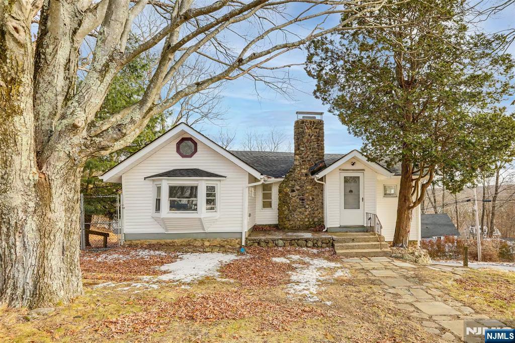 Beautifully updated 3-bedroom home offering a bright, open-concept layout and a perfect blend of modern updates and rustic charm. The main level features two spacious bedrooms, soaring vaulted ceilings, abundant natural light, and a stunning stone fireplace that serves as the centerpiece of the living and dining areas. The renovated kitchen boasts white shaker cabinetry, butcher block countertops, stainless steel appliances, and direct access to an expansive deck overlooking peaceful views ideal for relaxing or entertaining. The lower level includes a third bedroom and a lounging area. Additional highlights include updated flooring, recessed lighting, a one-car garage, and a private setting surrounded by mature trees. Conveniently located near shopping, dining, schools, and major commuter routes, this home also offers easy access to outdoor recreation, including hiking, fishing, boating, and year-round activities at nearby lakes, parks, and ski areas. This beauty delivers comfort, character, and a great location in the heart of Sussex County.