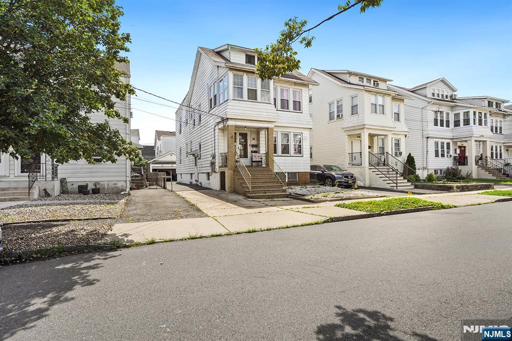 This charming two-family home with separate utilities, is tucked away on a peaceful, quintessentially tree-lined street and offers incredible potential. With solid original bones, abundant windows, wood floors, high ceilings, and a thoughtful layout, it's brimming with character. The long-time owners have lovingly maintained the property, adding to its appeal for multi-generational living or as a smart investment opportunity. A driveway, garage, and garden complete the picture. Conveniently located near the iconic Calandra's Bakery, transportation, shops, and major highways this is a rare find you won't want to miss. Come take a look and imagine the possibilities!