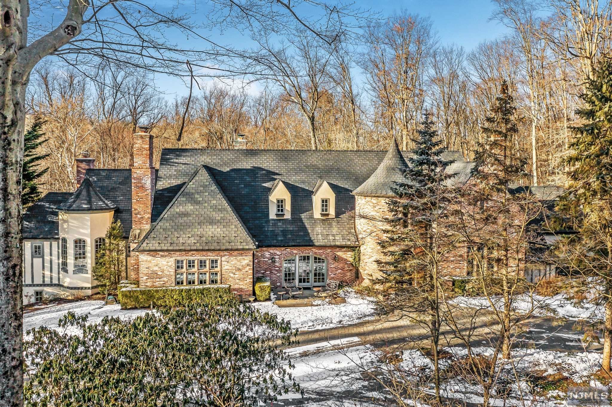 This stunning, architectural masterpiece is a private oasis, situated on almost three acres, in one of the most serene settings in town. With 5 bedrooms, 5 full and 2 half baths, this home offers everything today's buyers are looking for. Luxury features include magnificent woodworking throughout, 5 fireplaces, high end finishes, high ceilings, 3 car garage with Tesla charger, and a gorgeous pool. The first floor boasts a Primary Bedroom Suite complete with sitting room, spacious primary bath with double sinks, shower, tub and a large walk-in closet; Banquet Sized Dining Room, Chef's Kitchen, Family Room, Living Room, Laundry Room and Den. The second floor includes 2 unique bedrooms with a bath and 2 additional bedrooms with a connected bath. The spacious lower level has a walk out to the patio and pool, family room, gym/office, cabana bath with shower, bedroom with bath and ample storage. Don't miss this truly spectacular home!