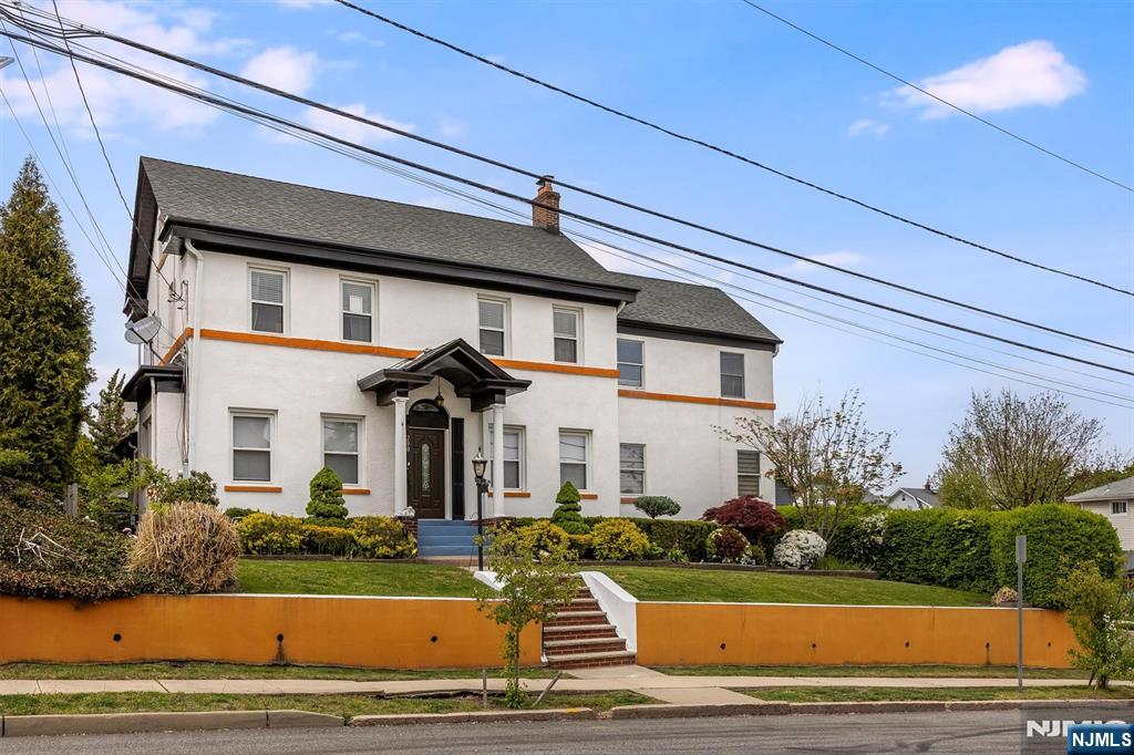 This stunning 1920s center-hall colonial effortlessly combines timeless charm with modern comfort. The first floor boasts a sun-filled family room, an open kitchen with a breakfast bar leading to sliders and a gorgeous backyard, formal dining room, living room with a beamed ceiling, cozy fireplace, and powder room. Upstairs, huge primary suite features full bath, an office, and tons of closet space, along with two more bedrooms and another full bath. The third floor offers two additional bedrooms and plenty of storage. The finished walk-out basement includes a den, laundry area, summer kitchen, full bath, and plenty of extra space with separate entrance. The yard features large deck and offers lots of privacy. The property also includes two-car detached garage and separate driveway for additional parking. Newer furnace, central AC, and H/W Heater. Conveniently located near the public library, park, Route 3, Route 46, and the Garden State Parkway, NJ Transit's Clifton Station is also nearby, providing an easy commute to Secaucus or Manhattan. Don't miss this exceptional opportunity!