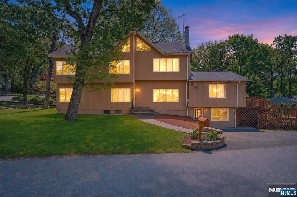 Updated 5BR Home with Soaring Ceilings, Mountain Views & Flexible Layout. Located in the highly desirable Dogwood community, this spacious 5-bedroom, 3-bath home offers dramatic living spaces, scenic mountain views, and a flexible layout designed for modern living. Set on a prominent corner lot in a safe, walkable neighborhood with strong schools, parks, hiking trails, and convenient access to Routes 208 and 287, the home combines lifestyle and location in one impressive package.The main living area features a stunning great room with soaring ceilings, recessed lighting, and an open flow into the family room and kitchen. Sliding doors lead directly to a brand-new elevated deck with panoramic mountain views perfect for entertaining or relaxing outdoors. Recent updates include new kitchen countertops and flooring, fresh paint, updated basement flooring, and modern finishes throughout.The upper level more like a true third floor than a traditional attic includes beautifully finished living space, custom designer windows, and additional scenic views. The lower level offers excellent flexibility with a full bathroom, updated flooring, and ground-level access, creating an ideal setup for guests, or extended living.Additional highlights include central air and heat, a large laundry room, all appliances included, and a bright, open layout that feels even larger in person. A move-in-ready home with space, views, and versatility in one of the area's most sought-after communities..