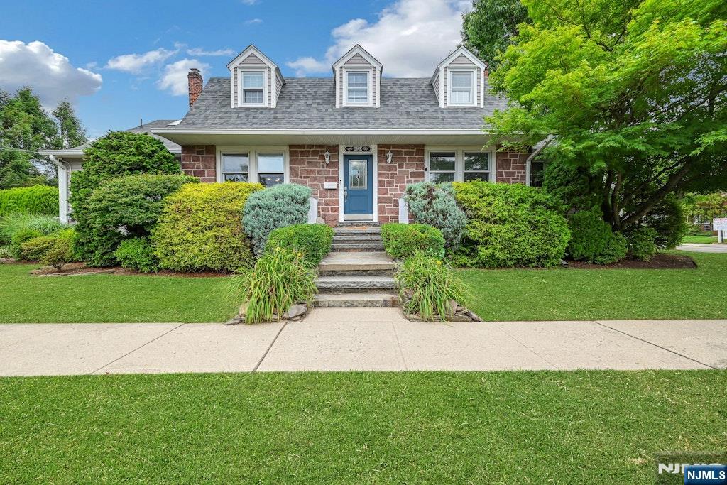 Beautifully maintained two-family home offering exceptional versatility for multi-generational living or rental income opportunities. Featuring an attractive brownstone façade, this spacious residence offers 5 bedrooms and 2.5 baths.The main living area welcomes you with an inviting entry foyer leading to a formal living room, dining room, two bedrooms (one currently utilized as a home office), a powder room, an eat-in kitchen, and a comfortable family room with direct access to a large private patioâ€”perfect for outdoor entertaining and relaxation. Upstairs, you'll find two generously sized bedrooms and a full bath. The primary bedroom includes an expansive bonus room ideal as a sitting area, home office, nursery, or dressing room. The lower level features a separate one-bedroom living space with its own entrance and address, full bath, living room, and dining area, providing excellent potential for extended family accommodations or supplemental income. Laundry facilities with separate hookups are also located in the basement.Car enthusiasts and hobbyists will appreciate the oversized detached two-car garage, complete with heat and electric service. A paver driveway provides parking for up to five additional vehicles.Conveniently located near downtown, schools, shopping, dining, and public transportation, this home combines space, flexibility, and an ideal location.
