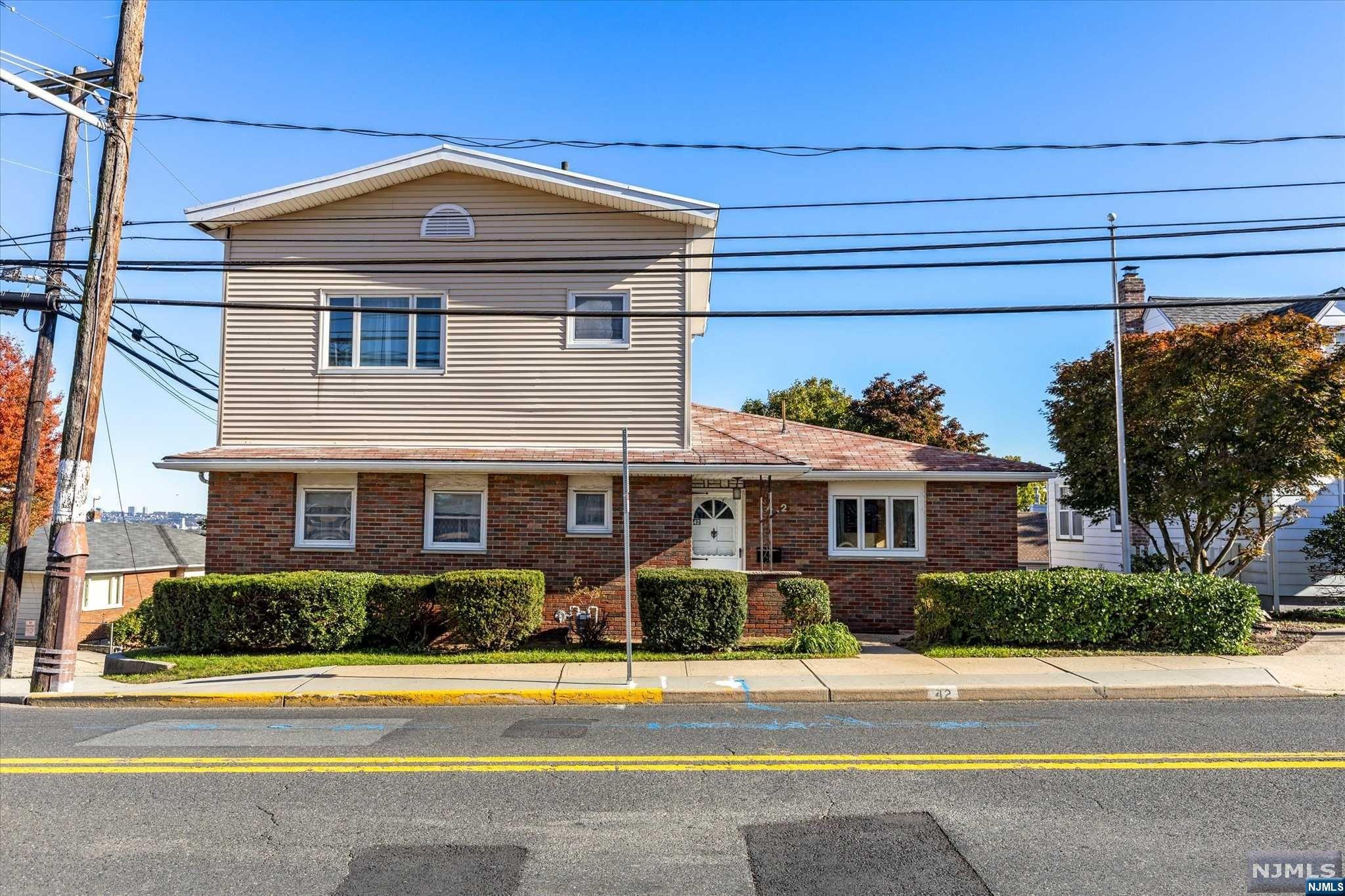 This is your opportunity to purchase this 2 family home with NYC views in this great town in Bergen County. This is an oversized home that features an Eat-in-kitchen, spacious dining room w/open concept living room where you will catch a glimpse of the NYC skyline & a reading nook perfect for home office. Primary En-suite with walk-in-closet and 3 additional bedrooms plus a full bath round out the main living space. Lower level features a game room, laundry room, utility room and workshop plus a 1/2 bath. Access to the yard and the 2 car garage. The upstairs unit features an Eat-in-kitchen with NYC views, living room with partition for home office, bedroom & full bath. Ideal location with close proximity to shopping, transportation, malls and so much more. Add your touches so you can call this HOME!