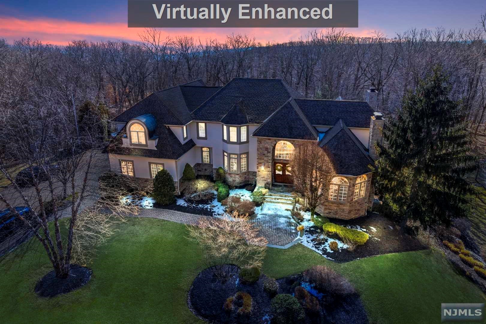 This custom-built private estate offers gorgeous mountain and woodland views. You are greeted by a detailed, double-story foyer entering the impressive great room, offering a bright living space with wood-burning fireplace, tray ceilings, oversized windows and cherry built-ins. This space features access to the deck, separate sitting room and parlor with a gas fireplace. The first level open floor plan includes a large dining room leading to the eat-in kitchen with a center island, breakfast nook and high-end appliances, access to the 3-car garage, powder room, laundry/mudroom and maid's quarters. Upstairs are four bedrooms and four bathrooms including the huge master suite, spa-like master bath and walk-in closet. The lower level features a beautifully-detailed wine room, movie theater, game room, exercise room, and an office. The lower level walks out to the beautifully landscaped, resort-like backyard, offering an in-ground salt water pool with a water slide and swim-up bar.