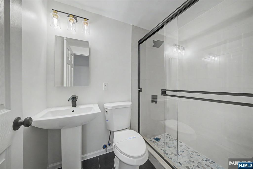 Nestled in the heart of Wyckoff this 4 BR, 4-bath home has been renovated in 2025-2026. Thoughtfully redesigned with high-end finishes, offering the perfect blend of sophistication, comfort, and flexible living space. Major upgrades include new boiler/heating system, (whole-house mini splits), hot water heater and roof, providing peace of mind for years to come. The Living Room boasts striking arched windows gracing a stately stone wood-burning fireplace. The inviting all-season room features skylights & newer Palladian windows. Step out to the spacious wraparound deck perfect for indoor-outdoor entertaining. The primary suite features a cozy fireplace and renovated Spa-inspired marble bath complete with frameless shower & panel system, freestanding soaking tub, decorative framed his/her mirror cabinets, premium bidet & private sauna. Every bath in the home has been newly renovated with upscale designer finishes & modern elegance. Fully finished walkout lower level expands the homeâ€™s versatility with a newly renovated private full bath & 2 separate office spaces. Private setting with expanded rear parking. This exceptional home offers incredible combination of luxury, functionality, & comfort inside & out.