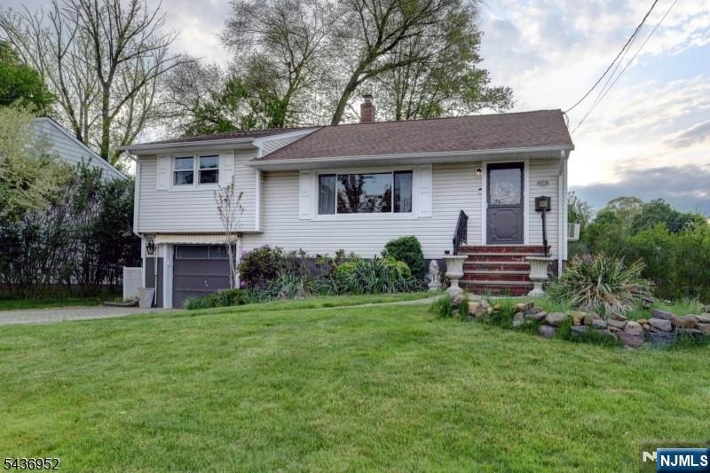 Turnkey mid-century back-split on a prime corner lot in the heart of Cedar Grove's "recreation corridor." This 3 bedroom 2 bath split features an open floor plan with gleaming original hardwood floors throughout, a sun-drenched eat-in kitchen with a pantry, and a dedicated dining area off the kitchen. The living room is highlighted by a large picture window that fills the home with natural light. The layout includes spacious bedrooms and ample closet storage, an updated bath with a marble-top vanity, and a finished basement perfect for a home office or gym. The backyard oasis features a massive paver patio spanning the entire width of the home, anchored by a high end steel pergolafeaturing a sheltered outdoor eating area. Unbeatable location with a short walking distance to the Cedar Grove Community Park, town pool, and municipal tennis/basketball courts. Major updates offer total peace of mind, including a 3-year old exterior (siding/shutters), 2 year old vinyl double-glazed windows, new double wide paver driveway, and 200 amp electrical service.Wall AC unit in living area. Close to major highways, transportation, shopping, parks, schools, and places of worship. Easy commute to NYC. You will love this one! Extensive home warranty included. Offers are being reviewed as they are received - do not wait!