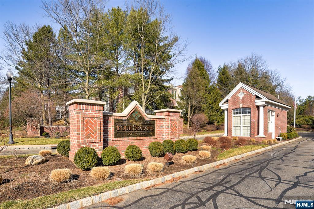 Welcome to Four Seasons, a vibrant and sought-after 55+ community, where this beautiful 2-bedroom, 2-bath CHERRY Model corner unit offers the perfect blend of comfort and convenience. Located on the 2nd floor, this bright and airy home features hardwood floors throughout the living room, dining room, and kitchen, a Jacuzzi jetted tub in the primary bath, and recent upgrades including a hot water heater, microwave, and HVAC system. Cozy up by the built-in smokeless fireplace on chilly nights, and enjoy the natural light streaming through windows on two walls. Two underground parking spaces and a secured storage unit are included, and you're just a short distance to the clubhouse, pool, tennis, pickleball, and bocce courts. Plus,enjoy easy access to the new Wayne Community Center, Aldi, and Trader Joe's.
