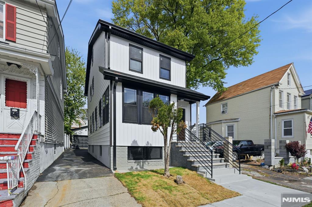 Stunning top notch modern single-family home offering 4 spacious bedrooms and 2.1 bathrooms, plus a finished attic and a fully finished basement. The first floor features a bright formal living room, an elegant dining area and a Beautifully designed kitchen featuring a center island with a built-in microwave space conveniently tucked underneath. sleek finishes and brand-new stainless steel appliances, along with direct access to a rear cozy deck. A convenient powder room and an enclosed front porch provide ideal space for a home office, sitting area, or flexible use. The second floor along with the finished attic offers four generously sized bedrooms and a full bathroom, providing comfort and versatility. The finished basement showcases an open-concept layout, a full bathroom and a dedicated laundry area. This home is equipped with dual-zone central air and HVAC systems for efficient year-round comfort. The exterior features a private driveway, an oversized detached garage and a cozy deck ideal for entertaining and outdoor gatherings. Truly turn-key and move-in ready, conveniently located near NYC transportation, schools, shopping and more. A must-see home that offers the perfect blend of style, space, and functionality!