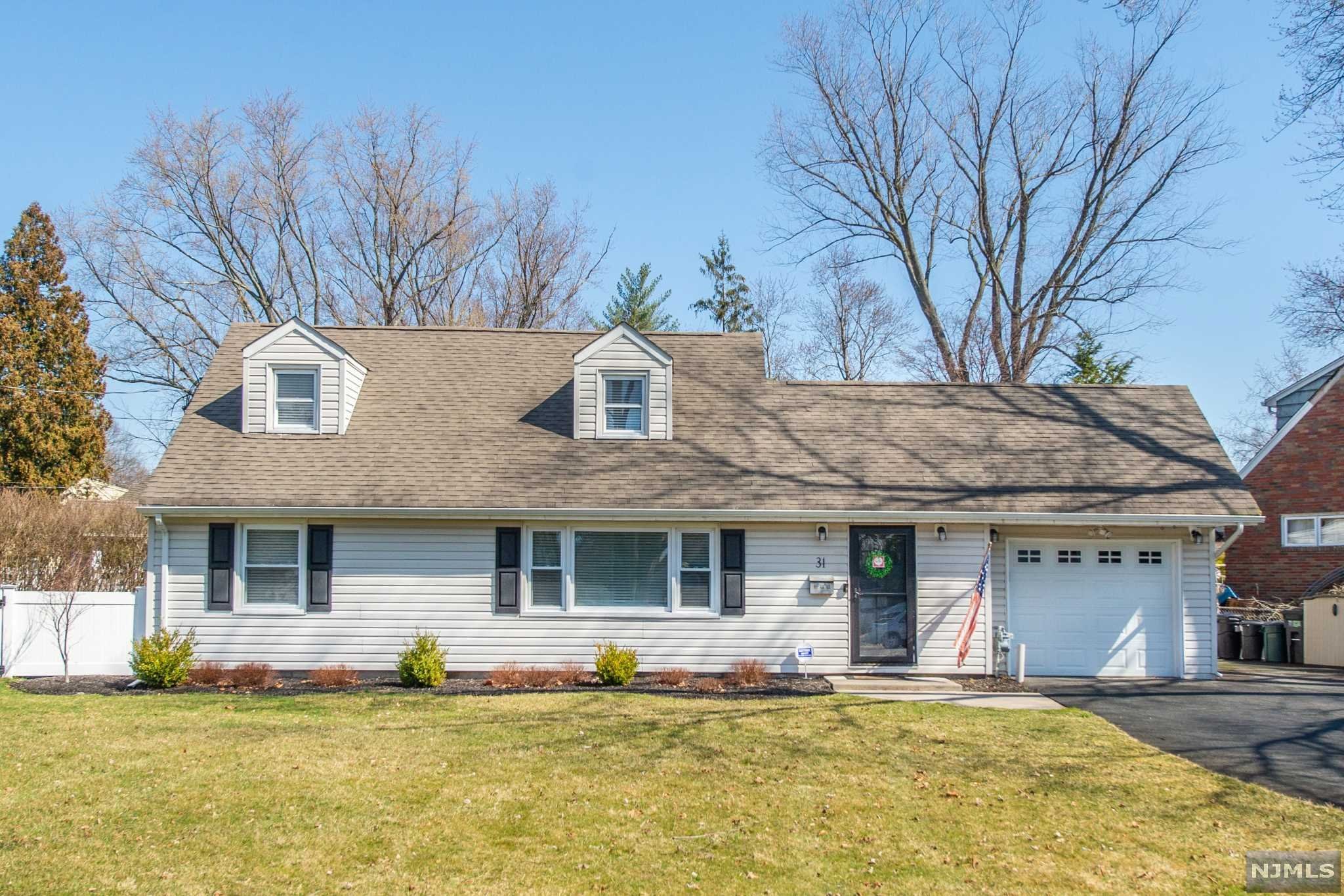Prepare to fall in love with this exceptional expanded cape in a great neighborhood and NO Flood zone. Situated on a large corner lot, this home has 4 bdrms, 2 bths, attached garage, large driveway, and too many updates inside to list! Main level includes exquisite hardwood flooring and has an open floor plan with dining room, living room, family room, recessed lighting, indoor/outdoor speakers, and pristine updated kitchen with oversized island including seating for three, quartz countertops, & all new stainless-steel appliances. French doors leading to oversized deck, fire pit, and large fenced in yard, perfect for entertaining. Main level also includes 2 bedrooms & a full bath with heated floor. Located upstairs is 2 additional bedrooms (one bedroom includes a walk-in-closet) & a full bath with full size washer & dryer. Ample storage with dual attic spaces. Close to shops, restaurants, Whole Foods supermarket, and highly rated Wayne schools. Don't delay, this one won't last.