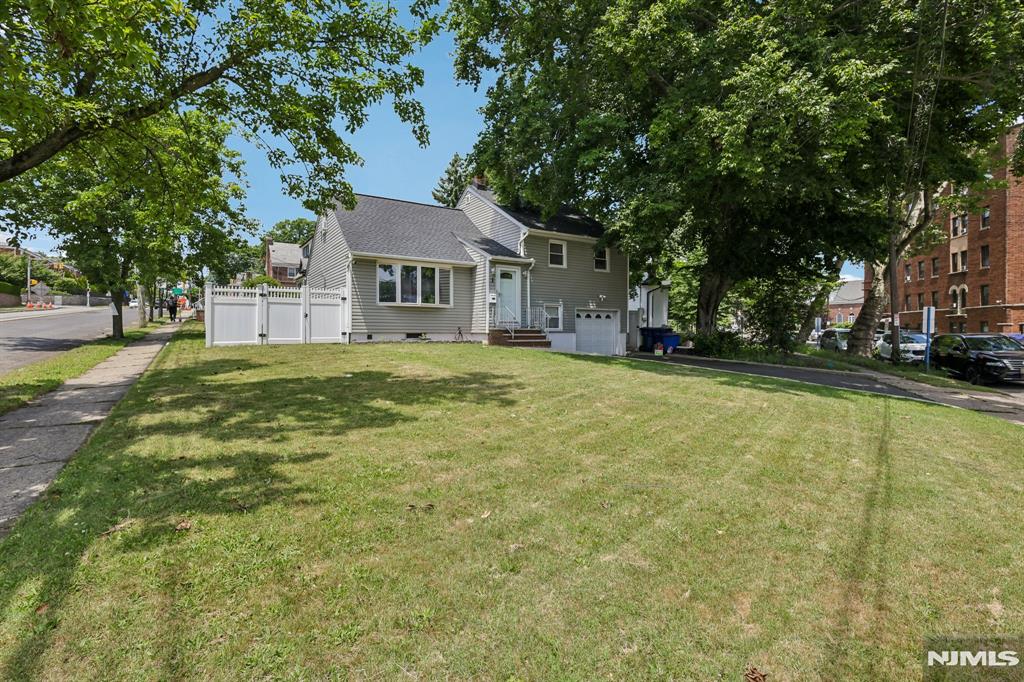 Amazing opportunity to own this beautifully maintained 3-bedroom, 2-bath Split-Level in Hackensack! Featuring an inviting living room with hardwood floors, a recently updated kitchen with granite countertops, with stainless steel appliances, and a dining room that's ideal for entertaining. Upstairs, you'll find three spacious bedrooms a recently renovated full bath and a walkup attic. The finished basement adds versatility for a recreation room, home office, gym or guest area. It also features a second renovated full bath, washer/dryer hookup, and abundant storage. Step outside to enjoy your huge, fenced backyard perfect for summer barbecues, outdoor gatherings. Additional features include an attached one-car garage, Tesla charger, and a storage shed. Conveniently located near NYC Express Bus service, Anderson Street Train Station, major highways, shopping, dining, and local amenities. A move-in-ready home with outstanding updates and commuter convenience don't miss this opportunity!
