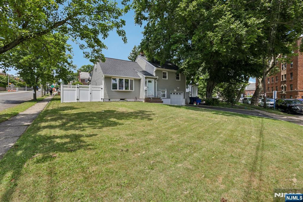 Amazing opportunity to own this beautifully maintained 3-bedroom, 2-bath Split-Level in Hackensack! Featuring an inviting living room with hardwood floors, a recently updated kitchen with granite countertops, with stainless steel appliances, and a dining room that's ideal for entertaining. Upstairs, you'll find three spacious bedrooms a recently renovated full bath and a walkup attic. The finished basement adds versatility for a recreation room, home office, gym or guest area. It also features a second renovated full bath, washer/dryer hookup, and abundant storage. Step outside to enjoy your huge, fenced backyard perfect for summer barbecues, outdoor gatherings. Additional features include an attached one-car garage, Tesla charger, and a storage shed. Conveniently located near NYC Express Bus service, Anderson Street Train Station, major highways, shopping, dining, and local amenities. A move-in-ready home with outstanding updates and commuter convenience don't miss this opportunity!