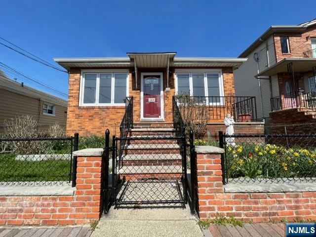 Beautiful well-kept brick 3 family with great layout. Main house features owner's unit, Dining/Living Room, EIK, Full bath, 2 Beds, plus finished basement with summer kitchen, living rm/rec rm with fireplace, full bath, laundry, utilities, driveway with 2 car garage. Rear house features two units, 1st fl 2 beds, living rm, eik, full bath, 2nd fl 2 beds, large living rm, deck off of one bedroom, kitchen, full bath. Great for owner occupied or investor/developer (50 x 1000 buildable lot for duplex).