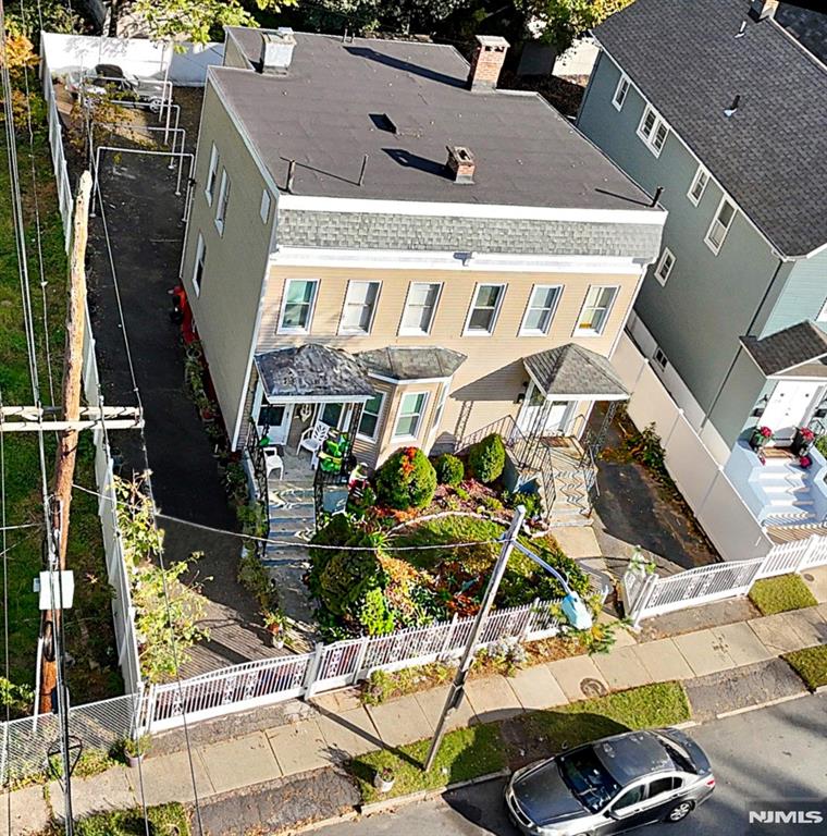 Welcome to 22-24 Kensington Place - 2 FAMILY in East Orange offering tremendous potential for owner-occupants looking to build equity. Each home features two levels of living space with a sun-filled living room, formal dining room, and large eat-in kitchen on the main floor. The second level includes two comfortable bedrooms and a full bath in each unit, providing generous room sizes and great layout flexibility. Both basements are walk-out and unfinished, each equipped with a half bath ideal for added storage or future expansion possibilities. Each unit has its own private driveway with ample parking, plus access to a shared backyard perfect for outdoor space enhancement. Located on a quiet residential street near schools, shopping, transportation, and major highways, this property is a rare opportunity to customize, renovate, and create long-term value in a convenient East Orange location.