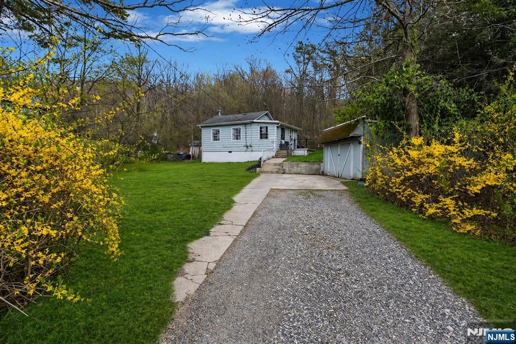 Charming and inviting, this 1-bedroom, 1-bath ranch-style home offers the perfect blend of comfort and simplicity. Designed for easy one-level living, the home features a bright and airy layout with a cozy living area and a well-appointed kitchen that flows seamlessly into the dining space. Step outside to enjoy a beautifully set-up outdoor area, complete with a spacious deckâ€”ideal for relaxing or entertaining. Whether you're enjoying morning coffee or hosting guests, the private backyard provides a peaceful retreat and backs directly to state land, offering added privacy and a serene natural setting. From the front porch, take in lovely lake viewsâ€”perfect for unwinding at the start or end of your day. Perfect for first-time buyers, downsizers, or anyone seeking low-maintenance living, this home delivers both convenience and charm in a truly special setting.