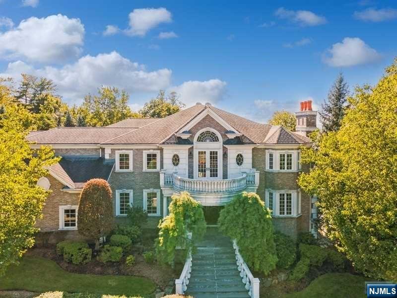 Perched high on a South-facing knoll, this perfect, private all-brick 6 bedroom meticulously maintained family colonial is now available for the first time to be enjoyed by a discerning buyer. Western-valley views can be enjoyed from multiple areas in a sprawling layout. Four generous-sized reception room on the main level include a living room, dining room, great room, library plus a large kitchen/breakfast area and a bedroom. The second floor accessible by both main and rear staircases has a large primary suite and three additional family bedrooms. All rooms have a towering view of either the valley to the West, the South facing swimming pool in the rear yard, or intricate rock cropping at the approach to the home. The lower level is large, with a great entertainment area, a theater room, plus a bedroom and bath. All accessible to a covered rear loggia and yard.