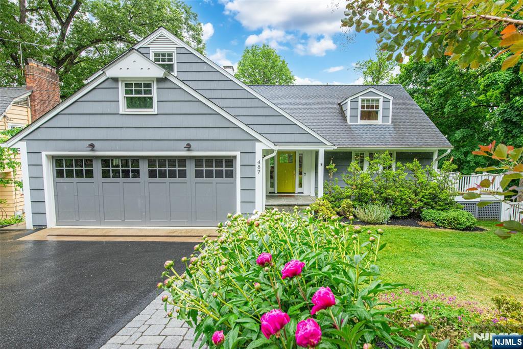 Tucked right next to Mountainside Park, this fully renovated contemporary colonial is all clean lines, great light, and zero projects to tackle. Redone in 2017, the house feels polished without trying too hard. Recent design updates seriously elevate the vibe; gorgeous lighting fixtures, statement wallpaper, and thoughtfully updated hardware throughout. With oversized windows everywhere you turn, the greenery outside becomes part of the experience, giving that dreamy "living in the trees" feeling.The kitchen is a home run: sleek finishes, high-end appliances, tons of prep space, and so open to the first floor. Nobody's stuck cooking alone while everyone else hangs out. Hardwood floors throughout - the layout just flows.Upstairs, the primary suite delivers with two walk-in closets and a spa-like bathroom featuring a double vanity and oversized shower. The lower level walks out to the yard and is super sunny, with high ceilings, polished cement floors, French doors, and major flex-space energy. Outside you are enveloped by lush, mature landscaping creating total privacy, and bursting with color all year long. The entire place feels peaceful, tucked away, and incredibly connected to nature. And somehow, while feeling totally secluded, you're still ridiculously close to Mills Reservation, the sledding hill, the Iris Gardens, public tennis and pickleball courts, the town pool, train, and Upper Montclair with shops and restaurants. It's the kind of location people wait years for.