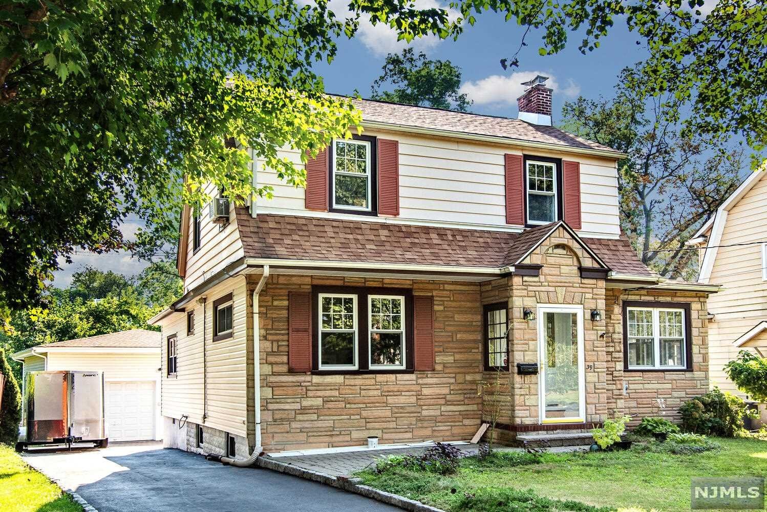 Expanded colonial! Gorgeous kitchen with center island! Two car garage! Enclosed entry foyer, spacious living room w/fireplace, good size den/office, banquet size dining room open to spectacular kitchen with stainless steel appliances and cabinets galore, large walk in pantry, convenient 1st floor bath. Upstairs three bedrooms and another bath. Basement is full/unfinished with 1/2 bath and lots of possibilities. Oversized 2 car garage with it's own 220 electrical panel, large 57 x 147 property, gas heat, close to school, local shopping & NY transportation.