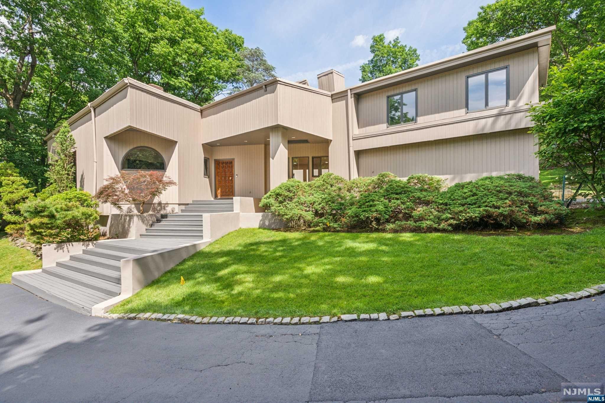 This unique home is built on rock with steel beam construction on 1.34 acres at the top of a Cul-de-sac! Perched high on a hill, this contemporary custom home has a personality and style all its own. Light and bright, this special home is one-of-a-kind and never duplicated. High ceilings - skylights - lofts and architectural nuances surprise and delight the senses. The main level showcases the many options from cozy groups to larger scaled gatherings! Surrounded by mature trees and nature! Large windows and sliding doors to multiple decks. The kitchen is the hub and centrally located for ease of everyday living and entertaining. The primary ensuite has an Art Deco feeling and is positioned on a separate floor with two office spaces awaiting your customization! The second level has a loft and additional three bedrooms and large bathroom set up. The two car garage leads into the main level of the home. Stairway from the hallway leads to a separate suite with bedroom and full bath.