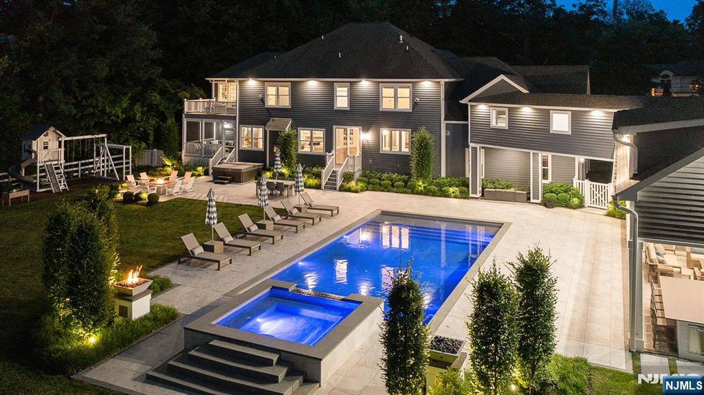 Welcome to your private Oasis an extraordinary Montvale estate offering resort-style living on over an acre of beautifully landscaped property. Designed for effortless entertaining and everyday comfort, this custom-built residence features expansive gathering spaces, a private office, first-floor guest suite, and a beautifully appointed kitchen with premium appliances, oversized refrigeration, generous workspace, and a dedicated beverage area. The second level is highlighted by a spacious primary suite with private balcony, custom closets, and a luxurious bath. Additional bedrooms offer a combination of en-suite and shared bath layouts, while a large recreation room and oversized laundry room provide added convenience. A striking second-floor bridge connects the main residence to a fully equipped pool house featuring a fireplace, full bath, radiant heat, built-in audio, and outdoor kitchen. Outdoor amenities create a true retreat with a heated saltwater pool, elevated spa, waterfalls, fire features, expansive patios, and multiple entertaining areas. The finished lower level offers additional recreation space, fitness area, and storage. Completing the property are an oversized three-car garage, mudroom, and convenient access to NYC transportation, the Garden State Parkway, premier shopping, dining, parks, trails, lakes, and top-rated schools. A rare opportunity to enjoy estate-style living with exceptional amenities in one of Montvale's most sought-after communities.