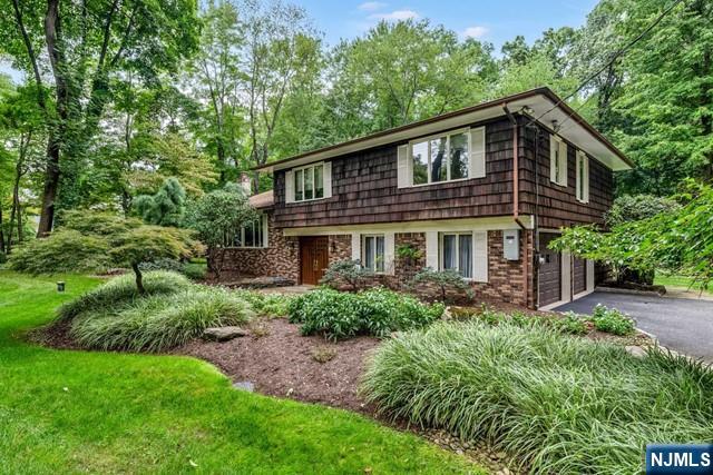 Beautiful home for rent in an amazing location in Demarest! Extremely spacious and well taken care property with 4 bedrooms + a den and 3 full bathrooms and an attached 2 car garage. The home sits on a park-like 1/2+ acre of property, with a huge backyard deck, surrounded by homes of great value. Split level layout with large LR, DR, and gourmet kitchen on the main level. Head up a few steps to the bedroom level with 4 large bedrooms and 2 full bathrooms. (Primary bedroom boasts luxury en-suite bath.) Ground floor Family Room, Den / Office, and 3rd full bathroom with laundry and garage access. Huge unfinished basement. Uniquely opportunity - the home is to be rented furnished, making move in a breeze. Tenants are responsible for all utiltities & snow removal. Landscaping taken care of. Very clean, comfortable, and spacious layout. A pet may be considered. AMAZING school system and wonderful community.