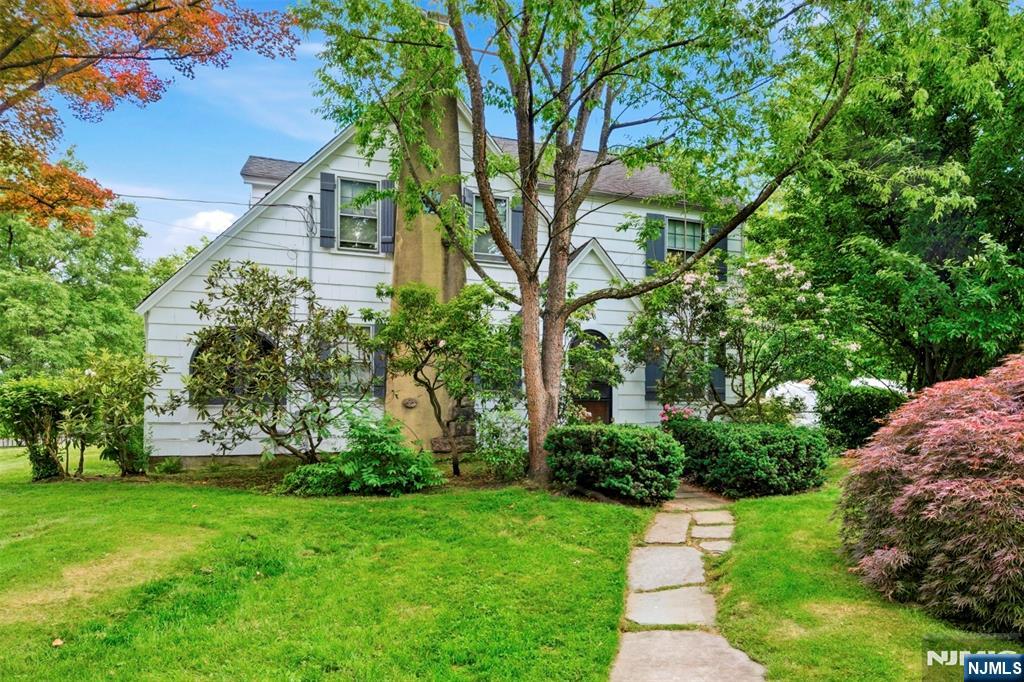 Charm and character abound in this 1935 Colonial on a spacious corner meticulously landscaped park like lot! Offered by a decedent of the original owners, this home has been very well cared for over the years! Features include a windowed closet in the foyer, hardwood floors throughout, a true chef's kitchen with professional range & hood as well as granite counters...the formal living room has a stone fireplace with wood mantle & slate hearth, the conservatory has beautiful curved windows all around, first level laundry room / mud room & pantry, a second mud room with an adjacent half bath, two full updated baths upstairs (one is primary ensuite & the hall bath still has the original tub + a half wall of original tile!), a very spacious secondary bedroom plus a third bedroom... the exterior offers custom arched windows and doorways as well as Japanese Maples, Rhododendron, Cherry and Peach Trees, Blueberry Bushes, beautiful flowers, and so much more! POSSIBILITES TO EXPAND WITHOUT GOING OUT ALTHOUGH THAT IS A STRONG POSSIBILITY TOO! Full basement and attic that can be dormered to add an additional approx. 1600 sqft! ALSO THE POSSIBILTY TO BUILD NEW ON THIS AWESOME LOT! A great location very close to the Millburn / Short Hills and Summit borders. Conveniently located two blocks from a bus to NYC Port Authority as well as in close proximity to a variety of shopping, restaurants, commuter routes and train stations, golf, parks and more! Well regarded school system. Come see it