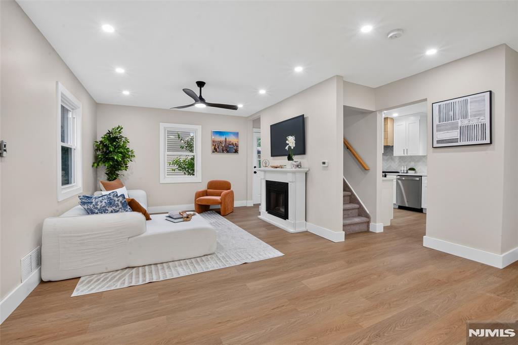 Beautifully renovated Sidehall Colonial offering modern finishes and an open, inviting layout. The main level features a spacious living room, dining room, and a modern kitchen complete with stainless steel appliances. A coveted first-floor bedroom and full bath provide excellent flexibility for guests or extended living. Upstairs, discover a generous primary bedroom, two additional bedrooms with beautiful new carpeting, and a second full bath. The fully finished basement offers valuable bonus space for a playroom and laundry. Additional highlights include central air, hardwood floors, and a 1-car attached garage. Situated in a highly desirable neighborhood, a true move-in-ready gem!