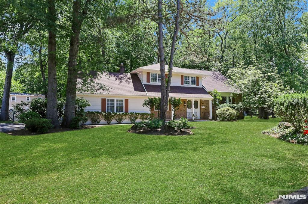 Very spacious Sugar Maple Split on tree-lined cul-de-sac! Fantastic, convenient location and neighborhood with easy access to Hwy 17 and GSP. Unlimited potential. Enter into the Den level of this home, which features a wood-burning fireplace and sliders to a large two-level deck and wide backyard. One bedroom on ground level too. Main level has wood floors throughout a large living room and formal dining room. The galley kitchen is spacious and has a separate casual breakfast area, also with sliders to the deck! 2nd floor has 3 bedrooms, including the original Primary BR with en-suite full bathroom, while the 3rd floor has another Primary with walk-in closet and vaulted ceilings. Basement is partially finished and offers future build-out possibilities. This property has a wide, level backyard with gorgeous shade trees creating a private retreat space. This is a special and unique home with lots of potential and must be seen in person! need TLC , House sold as is