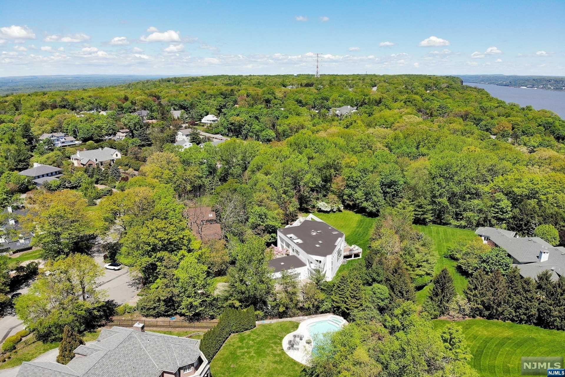 Meticulous design and luxurious finishes beautifully combine in this transitional contemporary masterpiece by renowned Architect Roland Scharfspitz. Gated & secluded with 6 beds & 5.5 baths, this opulent retreat is prepared to cater to all lifestyles. Nestled on a very private cul-de-sac in "Glen Goin Estate." Be greeted by the commanding entry way boasting double height ceilings for a seamless flow through all spaces. Bathed in marble, the gourmet kitchen by "Allmilmo" features an expansive center island, top-of-the-line appliances, extensive cabinetry & more. Escape to your lavish master suite w/ French doors to a private balcony overlooking the manicured grounds, sumptuous dual baths w/ 2 walk-in closets. The recently renovated lower level boasts high ceilings, entertainment area, office/gym, guest bedroom and full bathroom. First floor 3-car garage, minutes to the GW-Bridge, very close to some of the best Golf Country Clubs & top Schools in NJ! Enjoy the LOW TAXES