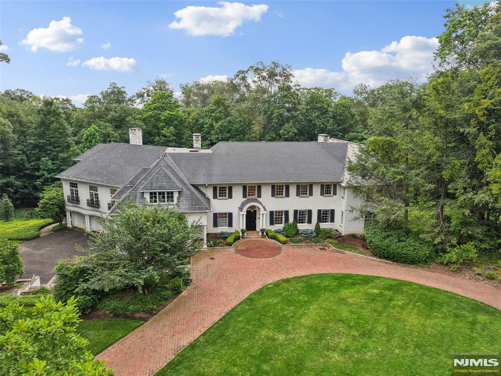 Magnificent country-club-like estate on 3 acres in a truly spectacular setting. Boasting impressive scale, this 8,627SF entertainer's paradise offers an extensive 2016 addition and backyard with a pool, cabana, multiple patios/balconies and fire pit. A grand 2-story foyer welcomes you to a 6-bedroom and 9 baths interior, beaming with indoor-outdoor flow and modern elegance. Seamless connectivity from the living room to a gourmet eat-in kitchen with high-end appliances/butler pantry, and a great room. A banquet-sized dining room, office, movie theatre, mudroom, and excellent space for extended family, including a bedroom, bath with sauna, and den wrap up the 1st level. Primary retreat with radiant heated flooring, walk-in closet, sitting room and spa-like bath. Extra living space in the basement with a billiard room, fully equipped bar, wine cellar, gym and ensuite bathroom. Extra highlights: 5 fireplaces, elevator, detailed millwork and a 5-car garage. The ultimate luxury home!