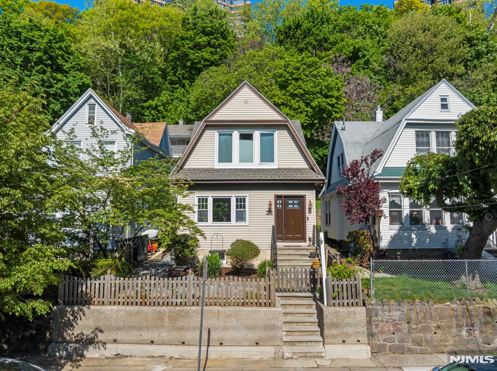 The only 1 family HOUSE under $1 Million in Edgewater for sale. This Edgewater gem awaits the next loving owner: A meticulously maintained 'Dutch Colonel' house lies on a large 30 x 125"ft lot. Many nice surprises await both inside and out; from the original stained-glass windows inside, to the nature embraced setting, outside. A sunny patio, complete with a birdhouse, greets you as you enter into the property. The house has a foyer w/an interior door, formal dining room, MEIK with a center island, a sliding glass door to the back yard, and solid oak HW floors throughout. Everything has been updated, and/or serviced recently, and it has a 1-year-old roof and mini split AC/Heat systems. The full basement has an additional shower and Bilko doors to the back yard. The back patio is great for relaxing, dining, and entertaining. It even comes with a country-like shed and borders the wooded mountainside. The property also has an â€œEco Friendlyâ€ landscaping design with flowers, plantings, and water erosion control, with gravel walkways, along pavers. Located right in the center of town near worship, EVG school, post office, Trader Joes, Whole Foods, and more.