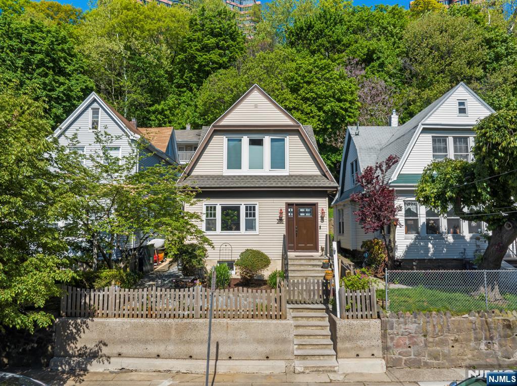 Another Edgewater gem awaits the next loving owner. This meticulously maintained Dutch Colonel house lies on a large 30 x 125"ft lot. Many nice surprises await both inside and out; from the original stained-glass windows inside, to the nature embraced setting, outside. A sunny patio, complete with a birdhouse, greets you as you enter into the property. The house has a foyer w/an interior door, formal dining room, MEIK with a center island, a sliding glass door to the back yard, and solid oak HW floors throughout. Everything has been updated, and/or serviced recently, and it has a 1-year-old roof and mini split AC/Heat systems. The full basement has an additional shower and Bilko doors to the back yard. The back patio is great for relaxing, dining, and entertaining. It even comes with a country-like shed and borders the wooded mountainside. The property also has an â€œEco Friendlyâ€ landscaping design with flowers, plantings, and water erosion control, with gravel walkways, along pavers. Located right in the center of town near worship, EVG school, post office, Trader Joes, Whole Foods, and more.