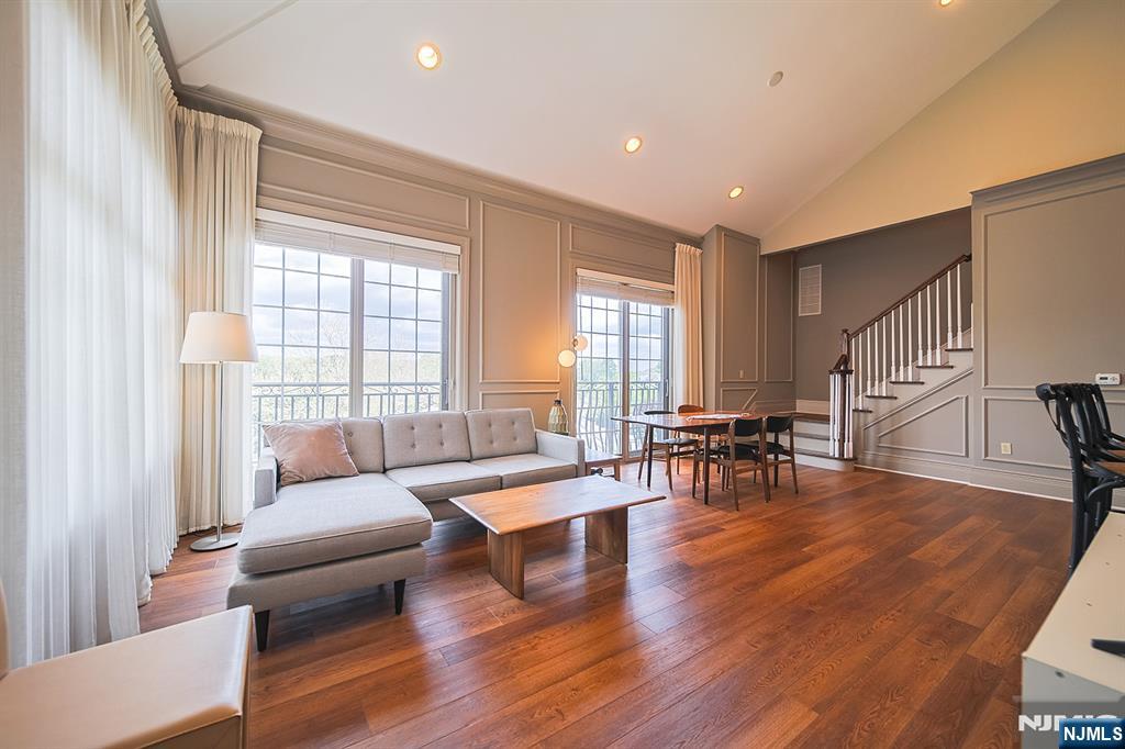 Step into comfort, elegance, and effortless living at The Plaza at Tenafly, a prestigious gated community located just minutes from Manhattan. This beautifully appointed residence welcomes you with elegant hardwood floors throughout the entry foyer, living room, and dining room, soaring ceilings, and oversized windows that fill the home with warm natural light. The gourmet kitchen is thoughtfully designed for both everyday comfort and entertaining, featuring custom cabinetry, granite countertops, a Sub-Zero refrigerator, dishwasher, microwave, spacious dining area, and the convenience of in-unit laundry. The serene primary suite features a private full bathroom, while a generously sized second bedroom and additional full hallway bath provide comfort and flexibility for guests or family. Residents of The Plaza enjoy an exceptional lifestyle with premium amenities including full-service concierge, outdoor heated pool, elegant entertainment lounge with billiards, state-of-the-art fitness center, media room with high-quality sound and video system, and a charming gazebo surrounded by beautifully landscaped grounds. This home also includes two assigned parking spaces â€” one indoor (#209) and one outdoor (#98) â€” both included in the monthly maintenance fee. Conveniently located near transportation, shopping, dining, and Blue Ribbon school district, this is a rare opportunity to experience luxury, comfort, and convenience in one of Bergen Countyâ€™s most desirable communities.