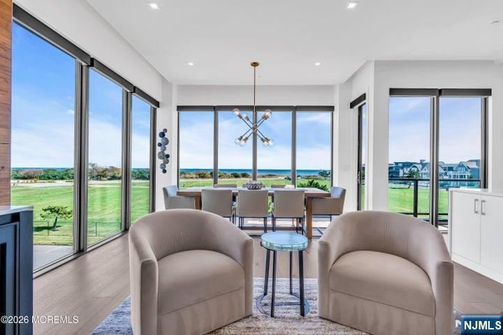 Panoramic ocean views await in this one-of-a-kind, 4-level townhome with over 3,100 sq. ft. of beautifully designed space all with panoramic views. This home offers a private elevator, 5 bedrooms & 5 full baths. A dramatic glass staircase with an Arctic White stone feature wall, sun-filled living areas showcase a walnut media wall and floor-to-ceiling panels of glass. The designer kitchen is equipped with top-tier appliances, quartz surfaces, and designer custom cabinetry. Upstairs, a private rooftop retreat steals the show with a built-in grill, firepit and breathtaking views of the Atlantic--perfect for unforgettable entertaining or quiet moments by the ocean.
