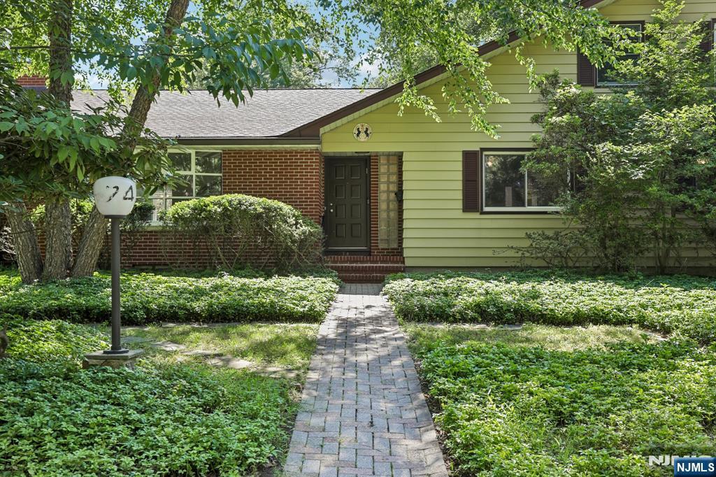 Spacious ranch located in the heart of desirable Harrington Park, directly across from George Street Park. Sun-filled living room showcases a wall of oversized picture windows, while the inviting family room features a modern brick gas fireplace. Elegant dining room offers wainscoting, chair rail and crown molding. Bright eat-in kitchen boasts abundant cabinetry, expansive countertops, and access to the backyard. 1st-floor bedroom includes a private full bathroom, two additional bedrooms and a full bath complete this level of the home. The second floor features a spacious master bedroom with oversized windows, walk-in closet, soaking tub, separate shower and oversized vanity. Office/possible 5th bedroom completes the 2nd level. The oversized finished basement offers exceptional flexible living space for a recreation room, media lounge, home gym, or play area, along with a laundry room, storage rooms and utility room. Enjoy the fully fenced private backyard with a custom paver patio, built-in curved seating around the fire pit, perfect for entertaining or relaxing. Additional highlights include a 2-car garage, underground sprinklers and house generator. Conveniently located near top-rated schools, parks, shopping, dining and NYC transportation.