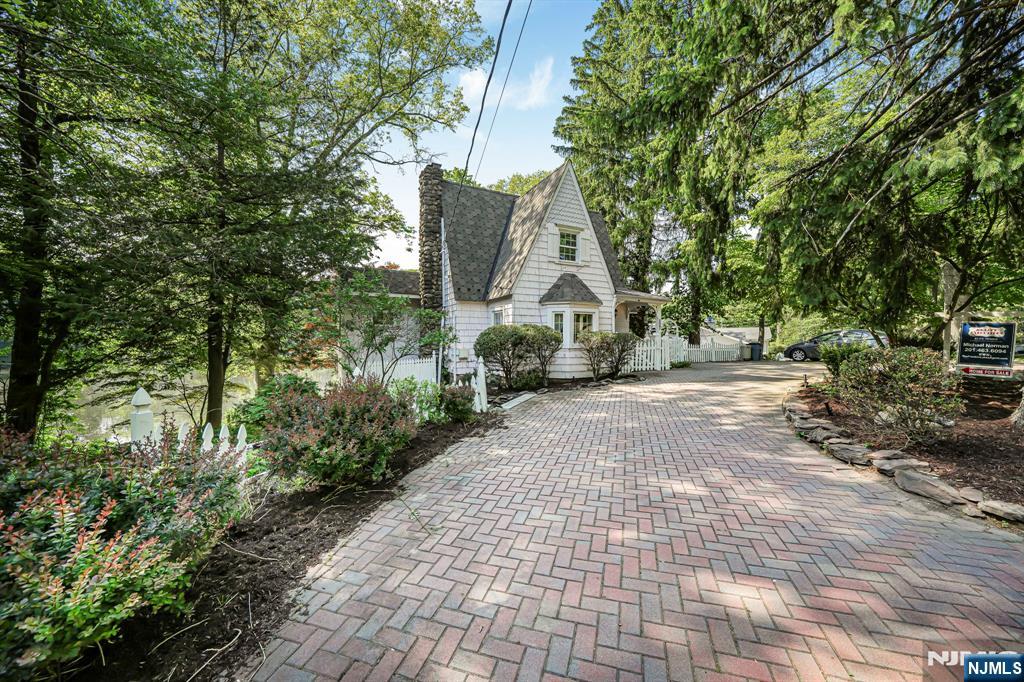 Welcome to this beautiful 3 bedroom 2.5 bath home nestled on Conrad's Pond in the heart of desirable Franklin Lakes. This cottage is brimming with so much charm and warmth. Step in and sit down by the beautiful wood burning fireplace, perfect for reading a novel or conversations with guests. Step out to your on you deck that overlooks the pond and your very own babbling Brook that flows down to your very own private dock where the blue heron can be seen nesting on the pond along with the turtles. A great place for yoga or morning tea! There is opportunity to expand and customize and enjoy what Franklin lakes as to offer. Top-rated schools, Tranquil setting, and convenient location to shopping, parks, and highways. This home is a must see! Lake dues are up to date & are $425 annually.