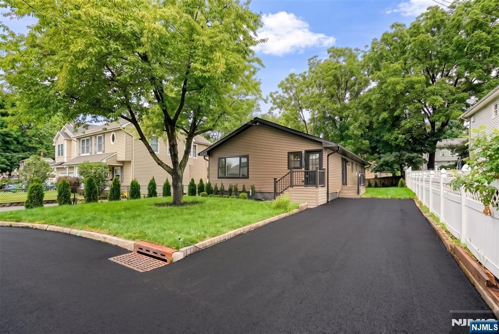 Completely renovated 3-bedroom, 2.5-bath ranch offering almost 1,700 sq. ft. of move-in ready living space in one of Mahwah's most desirable neighborhoods. This home has been thoughtfully updated from top to bottom, featuring a brand-new custom kitchen with solid wood two-tone cabinetry extending to the ceiling, quartz countertops, and brand-new stainless steel appliances. Additional interior upgrades include beautifully renovated bathrooms, brand new HARDWOOD flooring throughout, fresh paint, new molding, modern lighting, and stylish fixtures. Major improvements include brand-new central air, central heating, hot water heater, roof, siding, windows, gutters, driveway, front entrance, and professional landscaping. The spacious primary suite is privately situated away from the two additional bedrooms, offering added comfort and privacy. Enjoy a flat, beautifully landscaped backyard that provides the perfect space for entertaining or relaxing, along with an oversized driveway that accommodates up to four vehicles. Conveniently located near parks, shopping, restaurants, major highways, and NJ Transit, with the added benefit of low Mahwah property taxes. A rare opportunity to own a truly turnkey home where every detail has already been completed.