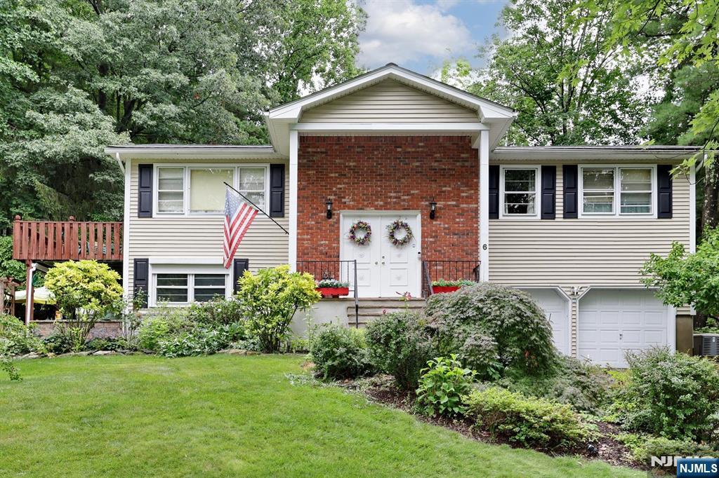Welcome to this beautifully maintained three bedroom, two and a half bath bi-level home tucked away on a quiet cul-de-sac in one of Wanaque's most desirable neighborhoods. Step inside to find hardwood floors, ceramic tile, inviting living spaces, and many thoughtful updates throughout. The outdoor setting is truly special, featuring lush gardens, a peaceful koi pond, patio, deck, and beautiful sunset views perfect for relaxing or entertaining. Additional highlights include a whole-house generator, water heater replaced in 2023, roof less than 10 years old, the was siding updated in 2015. A wonderful opportunity to enjoy comfort, charm, and outdoor beauty in a sought-after Wanaque location.