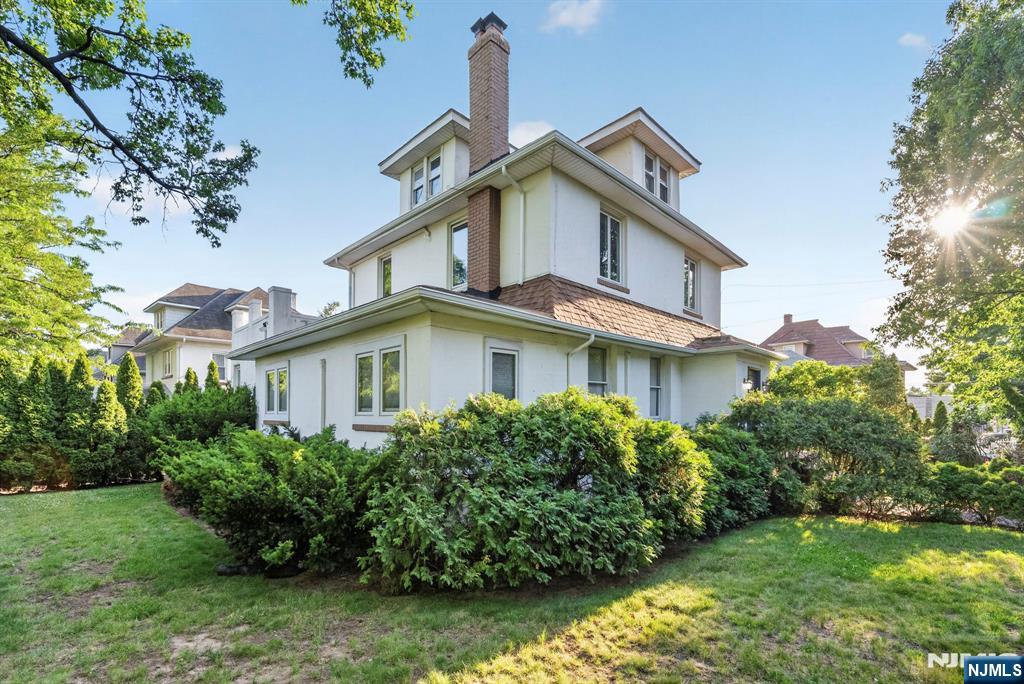 Rare opportunity to own this unique two-family home situated on a beautifully maintained corner lot in desirable Ridgefield Park. The property features a long private driveway leading to a detached two-car garage, offering abundant off-street parking and excellent curb appeal. The spacious primary residence is filled with character and showcases exposed wood beams, a wood-burning fireplace, a large formal dining room, kitchen, secondary bedroom, and a primary bedroom and en-suite bathroom that are ready for completion allowing the next owner to customize the space to their own taste(bathroom to studs with roughing and primary bedroom to studs). The recently renovated finished basement offers exceptional bonus living space with a full kitchen, recreation room, office or potential bedroom, and full bathroom. The second unit is a one-bedroom apartment featuring a living room, kitchen, bedroom, and finished walk-up attic, providing additional usable space. This property offers tremendous potential for investors, contractors, or owner-occupants looking to renovate and build equity. Conveniently located near parks, schools, shopping, major highways, and NYC transportation. Being sold strictly AS IS.