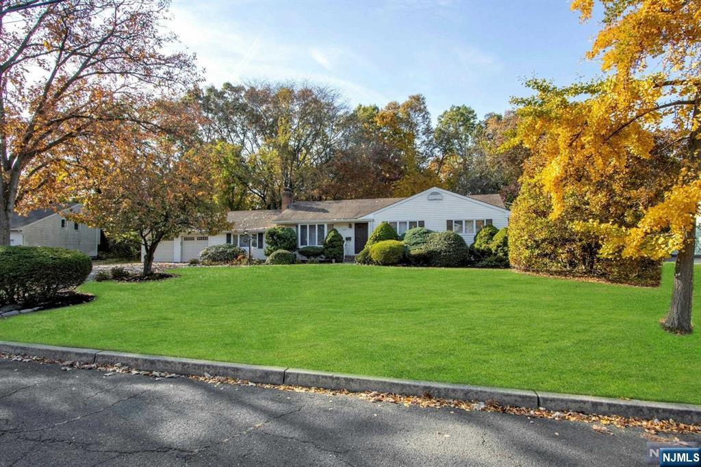 Spacious 4-BR Ranch with Expansive Yard in Desirable Washington Township! Discover this beautifully expanded ranch home, set on a serene half-acre lot. Step inside to find a large formal living room that flows seamlessly into a spacious dining room, perfect for gatherings. The heart of the home is a large eat-in kitchen, complete with a center island, rich wood cabinetry, and elegant granite countertops. Enjoy cozy evenings in the inviting family room with a charming brick fireplace and access to an all-season bonus room, providing year-round relaxation space. The primary bedroom suite includes a private full bath. Three additional large bedrooms, an extra bonus room, and a second all-season room completes the living space, providing comfort and versatility for everyone. Step outside to a lush, expansive backyard featuring a deck-perfect for outdoor entertaining. The property also includes a 2-car garage and a wide driveway for ample parking convenience.