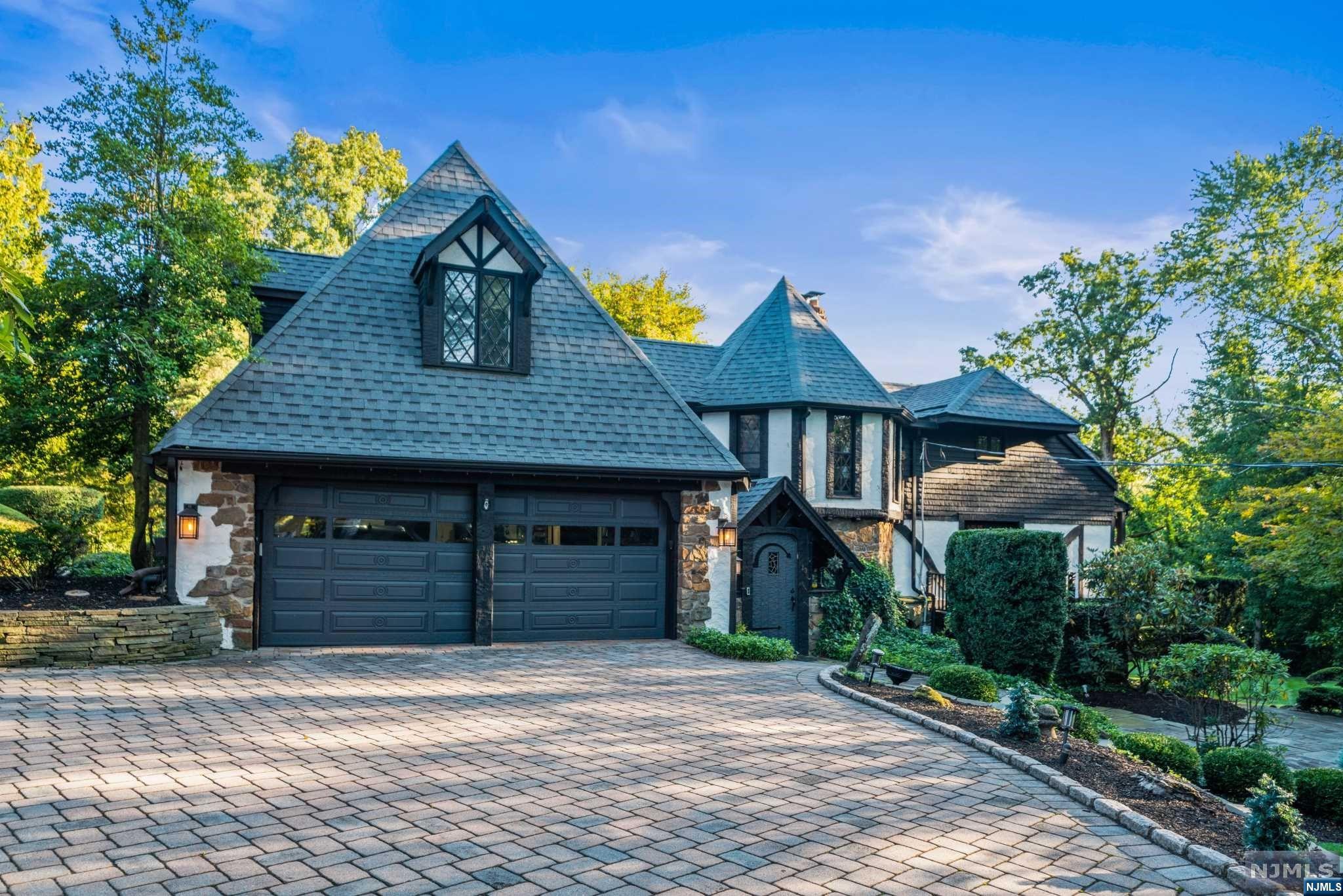 Step into this timeless masterpiece, a Bavarian Tudor home meticulously crafted in 1929 by artisan German brothers. Each piece of wood was hand-hewn, transforming a small barn into a legacy of craftsmanship. Today, the owners have expanded this 5-bedroom, 5-bath home, preserving its historic charm while adding modern elegance. Two in-law suites, an inviting kitchen w/quartz CT and 2-tone cabinets, and many living spaces make this home perfect for gatherings. The Primary bedroom inc. fireplace, 2 WIC and an amazing bath with clawfoot tub & huge walk-in shower. Outside, over 1.5 acres of lush land surround an in-ground pool, creating a private oasis. Embrace the past and present in this enchanting home, where history meets contemporary comfort. Welcome to a truly special place.