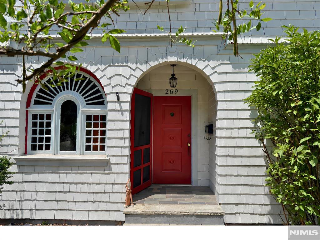 This postcard-worthy 1890 Victorian sits on nearly a half acre in the heart of West Montrose, close to Meadowland Park, bustling downtown, and two train stations with direct service to Penn Station. With five bedrooms, two-and-a-half baths, and ornate details throughout, the home offers timeless elegance while still feeling warm, welcoming, and compatible with modern-day living. Alcoves, nooks, and built-in benches appear throughout the home, creating inviting spots to read, nap, or just daydream. The newly updated kitchen features new cabinets, counters, and tile, plus a pantry and plenty of room to cook while guests sit, snack, and sip at the center island. Just beyond, a spacious den opens to a stunning wraparound porch overlooking the nearly half-acre lot. In the living room, warm up by the fireplace, watch the game, or settle in for movie night. Glass sliders frame views of the yard, where bunnies, deer, and other wildlife often pass through. The dining room adds another fireplace, a beautiful built-in hutch, and a wall of stained-glass windows. A half bath completes the main level. Up the grand staircase, the second floor offers three bedrooms and a beautifully appointed hall bath. A fourth bedroom opens to a deck overlooking the yard. The third floor includes an additional bedroom and full bath, creating a flexible space for a primary suite, guest suite, or private work-from-home space.