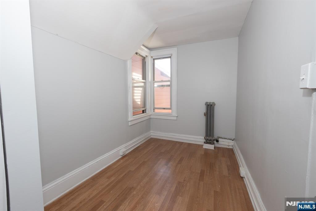 FIRST MONTH FREE! Welcome to this 3-bedroom, 1-bathroom, 2nd-floor apartment located at 297 West Broadway in the highly sought-after Hillcrest section of Paterson, NJ. This inviting unit features a spacious kitchen equipped with abundant dark cabinetry, a gas stove, a refrigerator, and stylish backsplash details. The living areas and bedrooms offer comfortable spaces with wonderful natural light, neutral grey paint tones, and easy-to-maintain flooring throughout. The full bathroom includes a classic tiled tub and shower combination with a standard white vanity and mirrored medicine cabinet. As a wonderful bonus, residents will enjoy access to the fenced backyard, providing a great outdoor space to relax. This home is conveniently situated close to local amenities, shopping, and major transportation routes. Background check, credit check and income verification required.