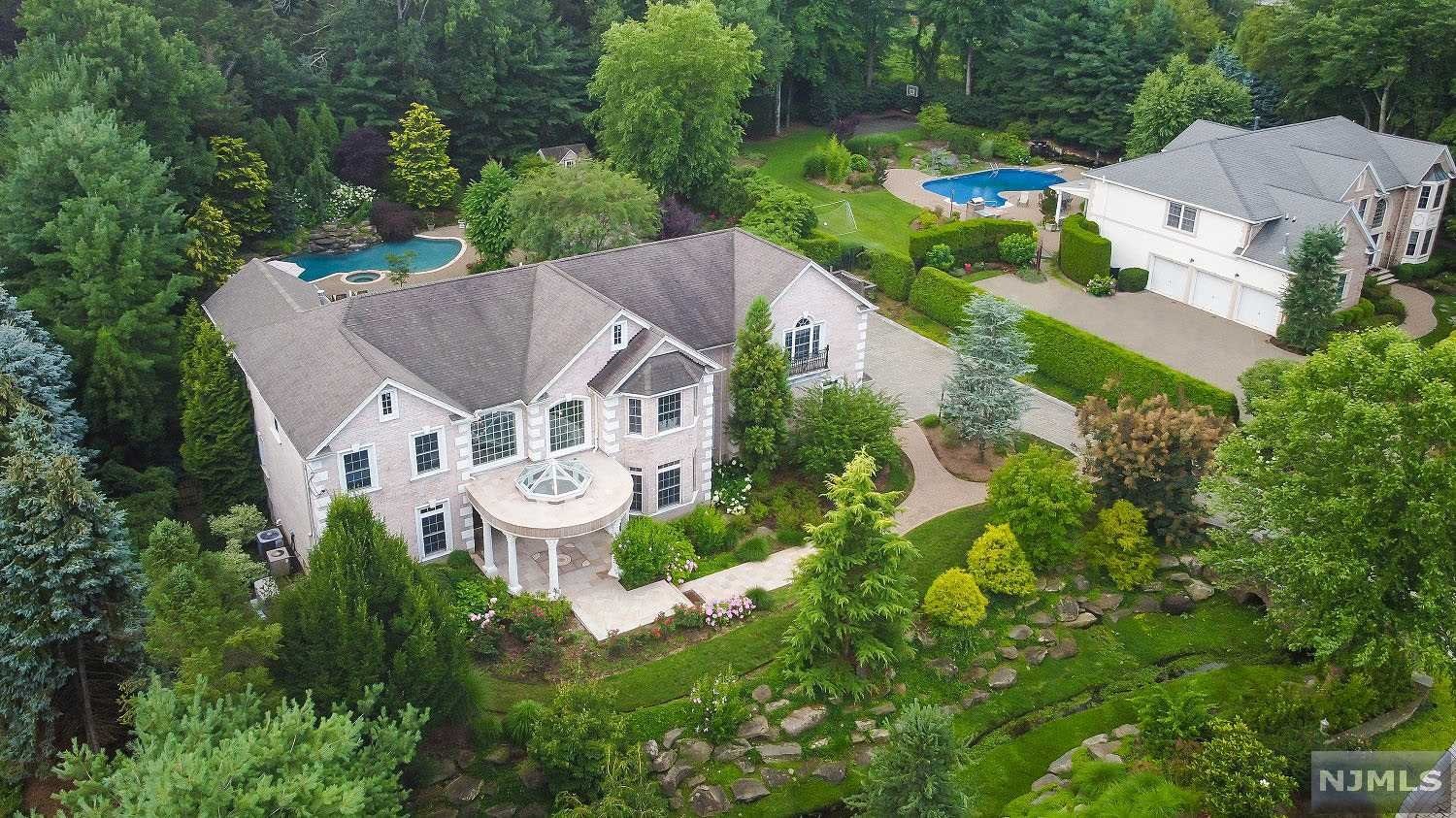 Nestled among a canopy of mature trees, this exquisite, private estate sits on a resort worthy property for gracious entertaining & living. An impressive 2-story foyer opens into a light filled Great RM w/grand fplc, timeless crown moldings & French doors leading to the covered loggia. Gourmet Kitchen features 2-tier center island, butler's pantry, high-end SS appliances. 2nd fl. has access to a terrace & features a mahogany-paneled office, luxurious Primary Suite with lounge & dressing areas, 3 WICs, newly renovated ensuite BA. Family & guests will love the 5 addl. BRs and BAs, incl. 1st FL ADA Compliant BR Suite w patio access. Lower Level incl. large lounge area, BR, wet bar, large cabana bath with walkout access to a yard that boasts an outdoor kitchen, pool with waterfall, pond, spa & unique spiral staircase to the 2nd Fl terrace. Multi zone heating, full-house generator, high end security system. Gated driveway. No detail has been spared in this impeccable home.