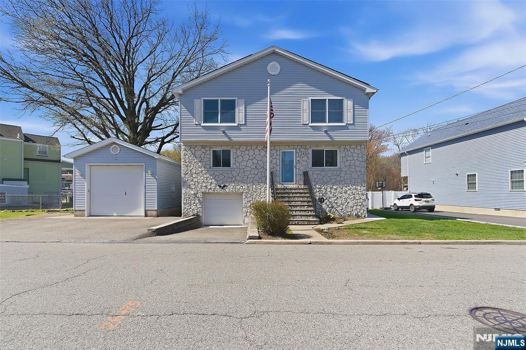 Welcome home to this meticulously maintained, move-in ready home. Situated on one of Little Ferryâ€™s most highly sought-after, non-flood streets this charming 4 bed, 2 bath Colonial offers timeless character with modern updates. The main level offers hardwood floors, a bright layout, and a cozy stone hearth equipped with a warm wood-burning stove. The kitchen features beautiful granite countertops and tile flooring, flowing naturally toward a spacious rear deck designed for outdoor dining and entertaining. Upstairs, the home offers 4 bright, generously sized bedrooms, a full bath with an updated soaking tub, and access to storage attic. The newly finished basement is equipped w/ waterproof flooring, modern lighting, dedicated laundry space, and direct access doors to both the attached garage and the backyard. Optimized for modern efficiency, the home has solar panels to lower utility costs, a newer hot water heater, hardwired smoke alarms, and a Ring spotlight security network. The exterior grounds feature a deep, unique lot that provides extra backyard privacy and layout flexibility. This property features a large, heated detached 2nd garage structure with its own electrical panel. This bonus space is a rare find, serving as the ultimate dream workshop for mechanics and hobbyists, or providing secure storage for commercial vehicles. Perfectly located close to local schools, parks, neighborhood shopping, and commuter transit to NYC, this home is ready for its next chapter.