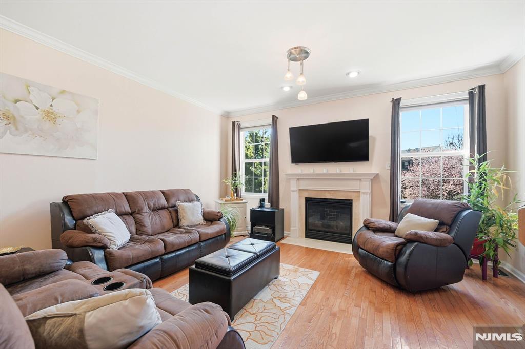 Located in sought-after Cambridge Heights at Nutley, this spacious townhome offers over 2,000 sq ft of sun-filled living space, 3.5 bathrooms, and a layout that stands out from similar models currently on the market with the addition of a rare FULL bathroom on the lower level ideal for guests, a home office, gym, media room, or flexible extended living. The KITCHEN RENOVATION (2020) features custom wood cabinetry, granite countertops, stainless steel appliances, center island, and a bright dining area. The open-concept living and dining spaces showcase soaring ceilings, recessed lighting, a gas fireplace, and UPGRADED FLOORING (2023) throughout much of the home. Upstairs, the primary suite offers oversized closets and an en-suite bath with soaking tub and separate shower, while the second bedroom is generously sized with nearby full bath access. The expansive lower level includes garage access, abundant storage, walkout access to a private patio, and an open backyard setting rarely found within the community. Additional highlights include NEW HVAC (2022), WATER HEATER (2024), NEW ROOF (2026), guest parking nearby, and access to Cambridge Heights amenities including pool, fitness center, tennis courts, clubhouse, and gated entry all conveniently located near NYC transportation, shopping, dining, and major highways.