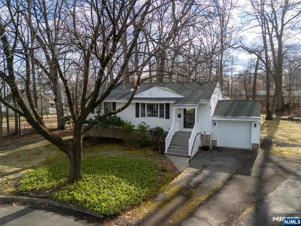 Nestled at the end of a quiet cul-de-sac in one of Little Falls most sought-after neighborhoods, this beautiful ranch offers the perfect blend of charm & modern updates. Inviting LR features gas FRPLC & LGR picture WNDW, while the open flow to the FDR is enhanced by an elegant arched opening. Main level includes spacious primary BR, 2nd BR, & BTH w/decorative tile. EIK boasts white CABS, subway tile BCKSPLSH, quartz CNTP & S/S appls, perfect for casual dining. Charming screened-in porch w/cathedral CEIL & CEIL fan offers a peaceful view of private backyard oasis, ideal for relaxation. Backyard also features a slate patio perfect for unwinding or entertaining. GAR provides convenient access to the backyard. Finished BSMT adds valuable living space w/FR, office nook & BTH. Add'l features - CRWM MLDG, HDWD, & SECSY. Updates - Furnace (2019) & ELEC (2020). Ideally located for commuters, train station & NYC bus stop close by as well as restaurants, shopping, parks, schools, & major HGHWYS.